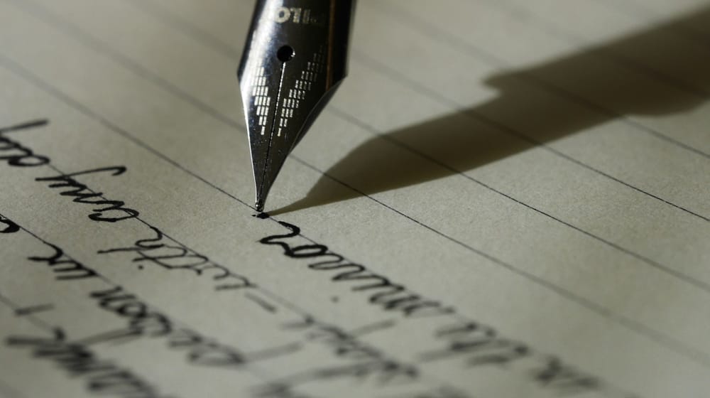 Fountain pen writing on paper, a reminder that human editing still shapes good content