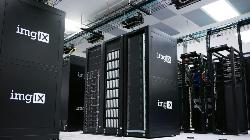Rows of server racks in a data centre, where single-region websites and databases run