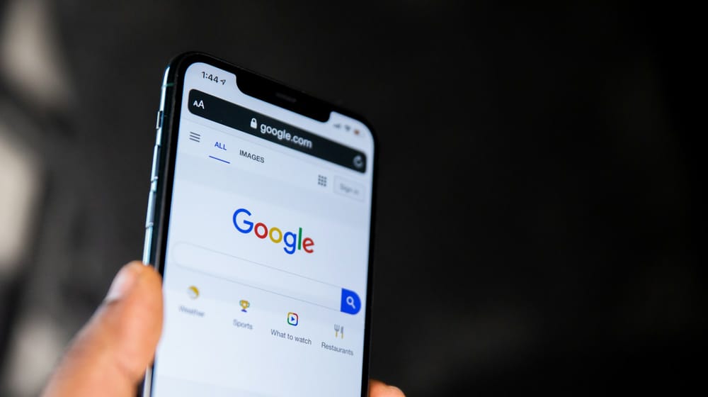 Hand holding a phone showing Google search results, where Next.js metadata becomes visible