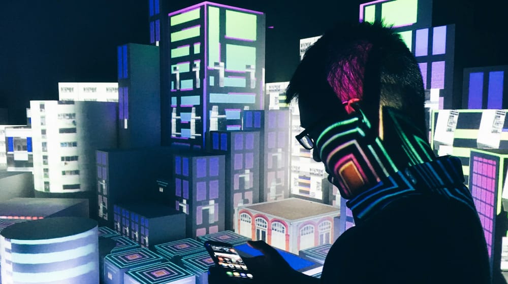 Person inside a futuristic room full of screens, reflecting where web development is heading