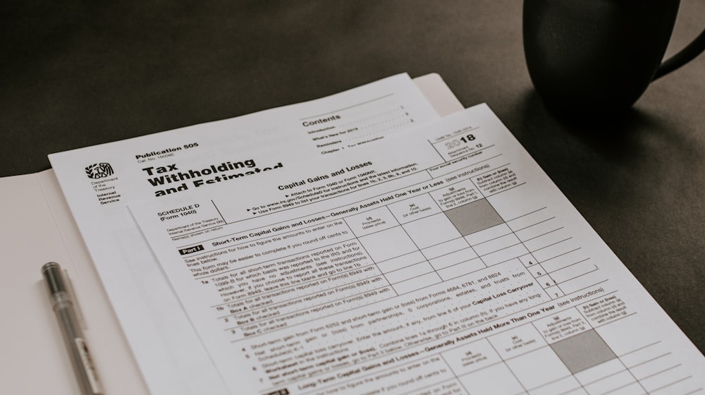 Person completing a form at a desk