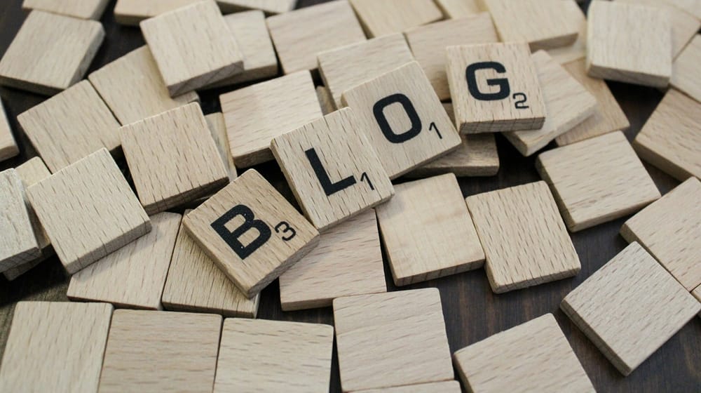 Wooden letter tiles spelling BLOG, representing content built from WordPress blocks