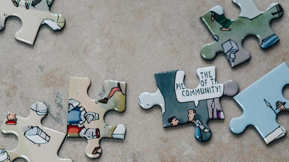 Jigsaw puzzle pieces on marble, like plugins that must fit together without conflicts